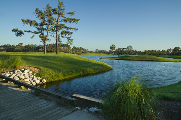 Beautiful blue lake under the bridge at the golf course 