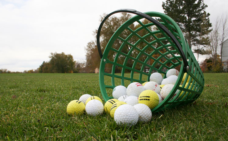 tipped over bucket of golf balls